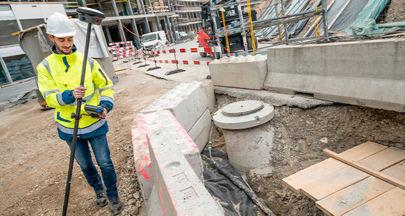 A surveyor measuring trench with Leica GS18I